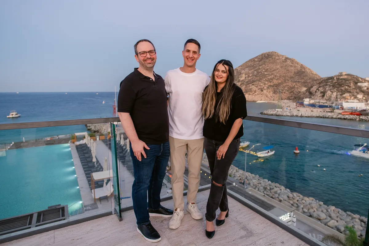 Handl Health team members together on a rooftop overlooking the coast